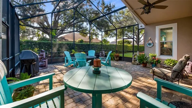 a backyard of a house with table and chairs