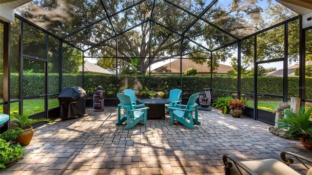 a dining room filled with furniture and a chandelier