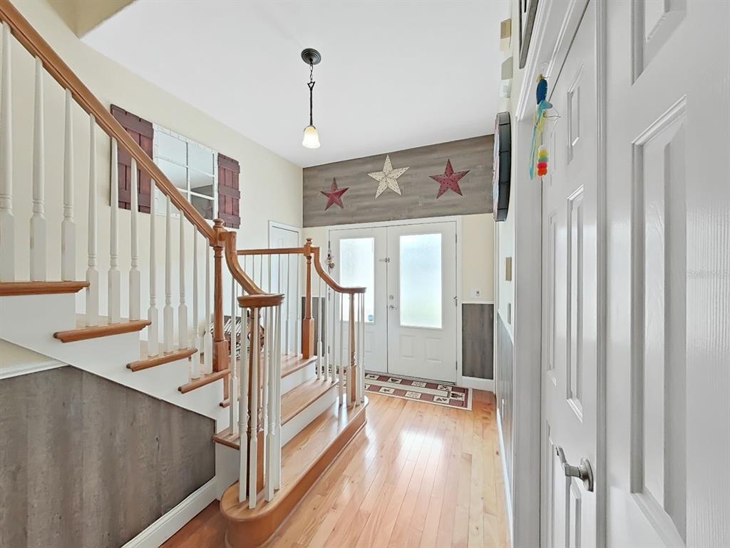 10639 Brave Lane Hudson, FL 34667 - Photo 16 of 54 a view of entryway and hall with wooden floor