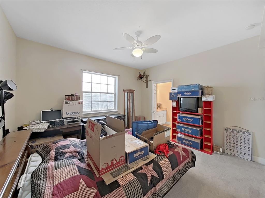 10639 Brave Lane Hudson, FL 34667 - Photo 21 of 54 a bedroom with furniture and a chandelier