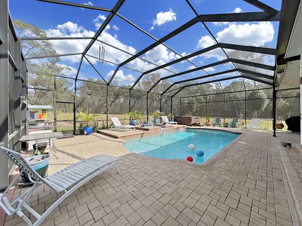 10639 Brave Lane Hudson, FL 34667 - Photo 30 of 54 a view of a swimming pool with a patio