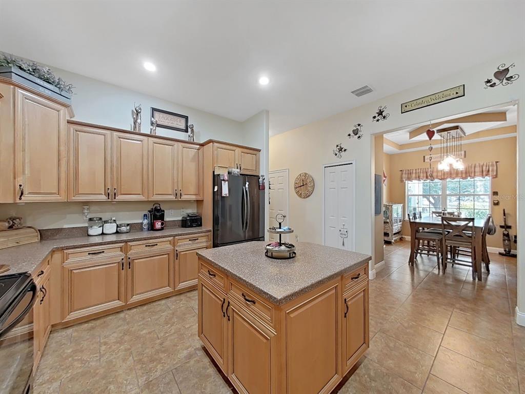 10639 Brave Lane Hudson, FL 34667 - Photo 4 of 54 a kitchen with stainless steel appliances granite countertop a sink stove and refrigerator