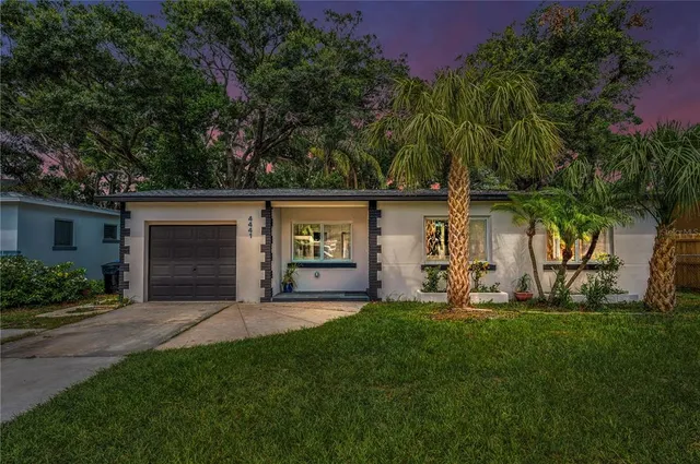 a front view of house with yard and outdoor seating