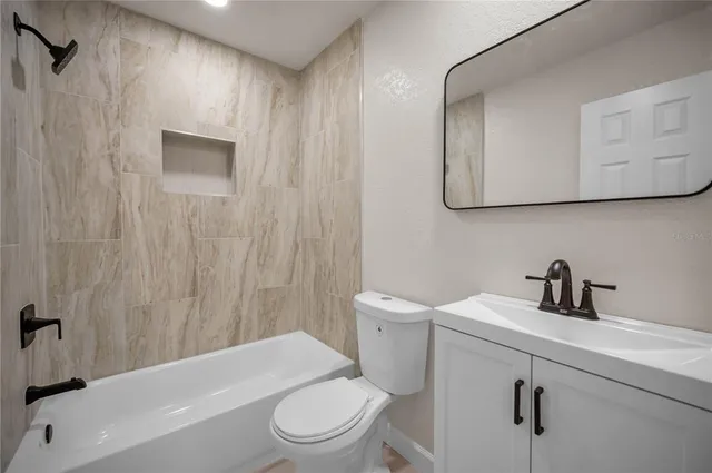 a bathroom with a toilet a sink and bathtub