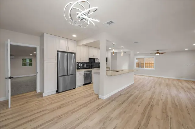 a view of a kitchen with a sink and refrigerator