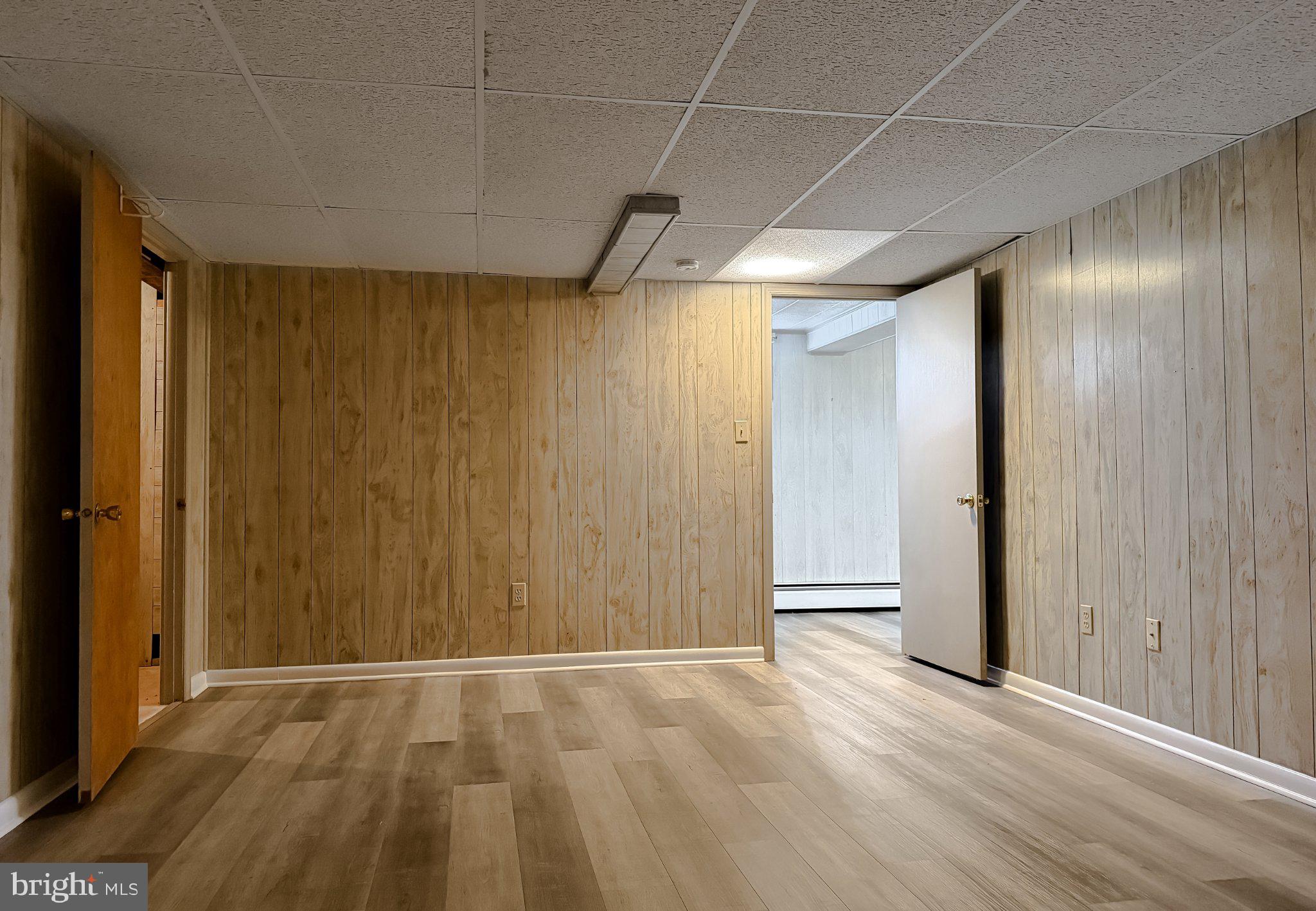 23230 Colton Point Road Avenue, MD 20609 - Photo 46 of 63 Spacious basement with warm wood tones.