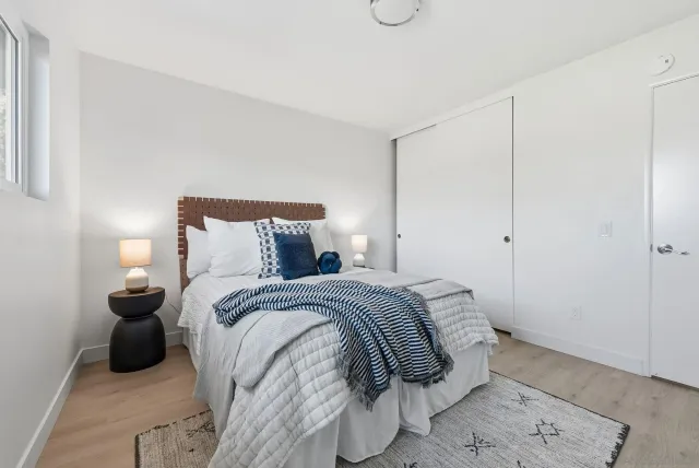 a bed room with a bed and a night stand