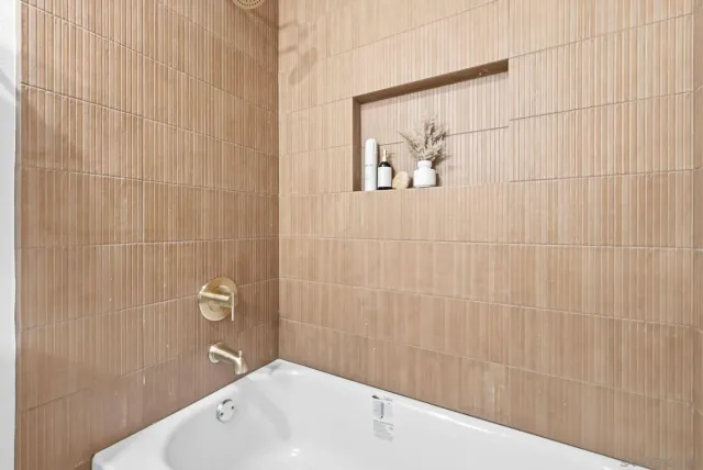 a bathroom with a shower and a sink