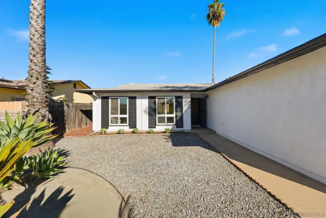 a view of a house with a tree in the background