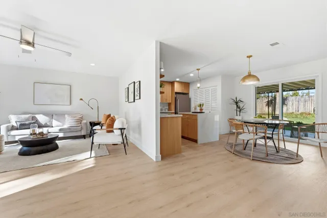 a living room with furniture and kitchen view