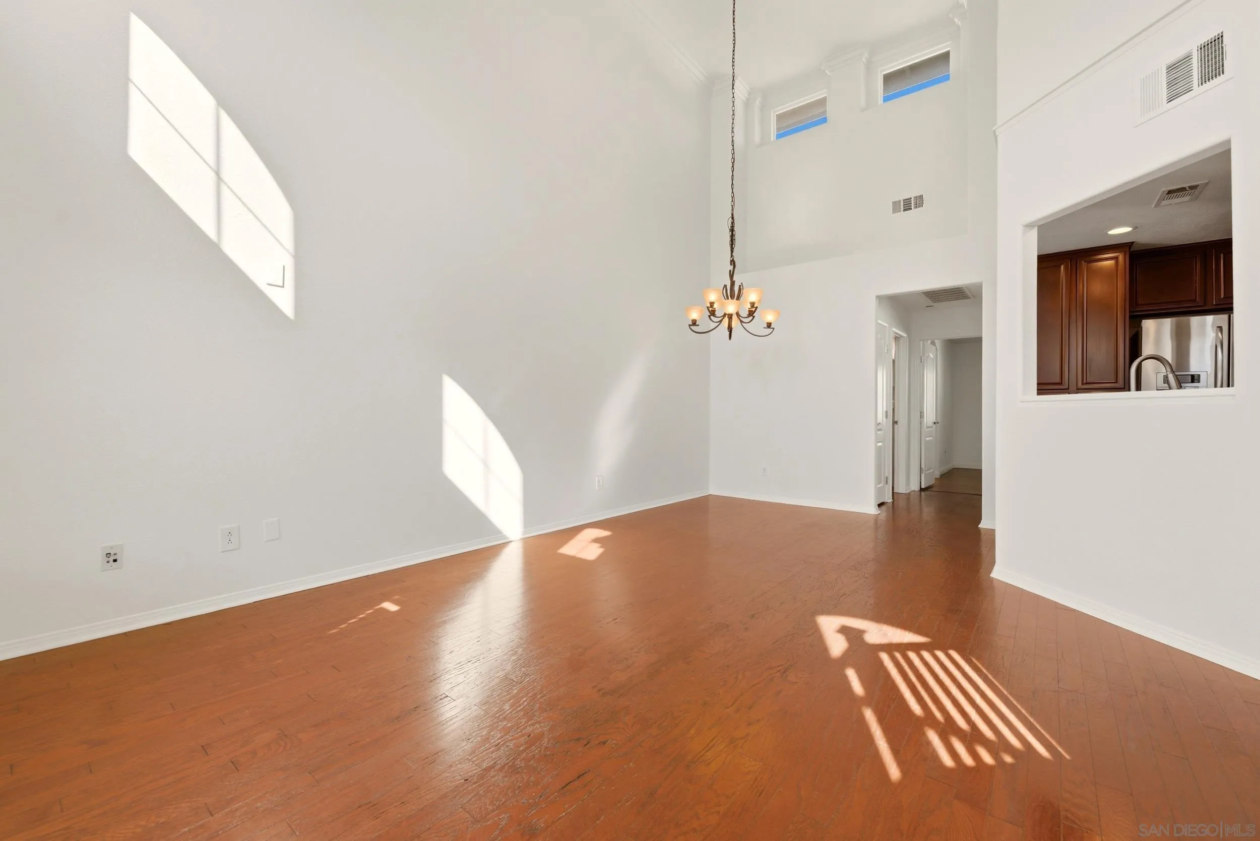 16953 New Rochelle Way, Unit 62 San Diego, CA 92127 - Photo 4 of 21 a view of an empty room with wooden floor and a window