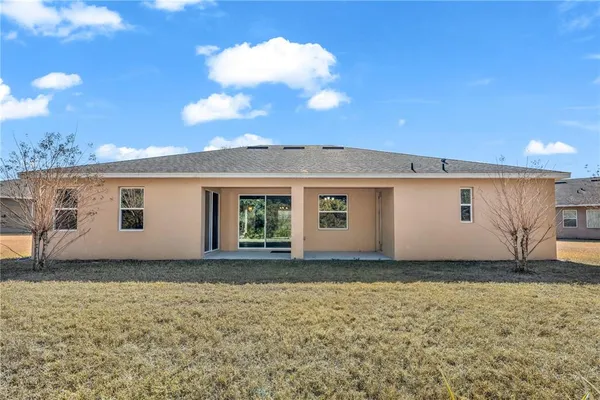 a view of a house with a backyard