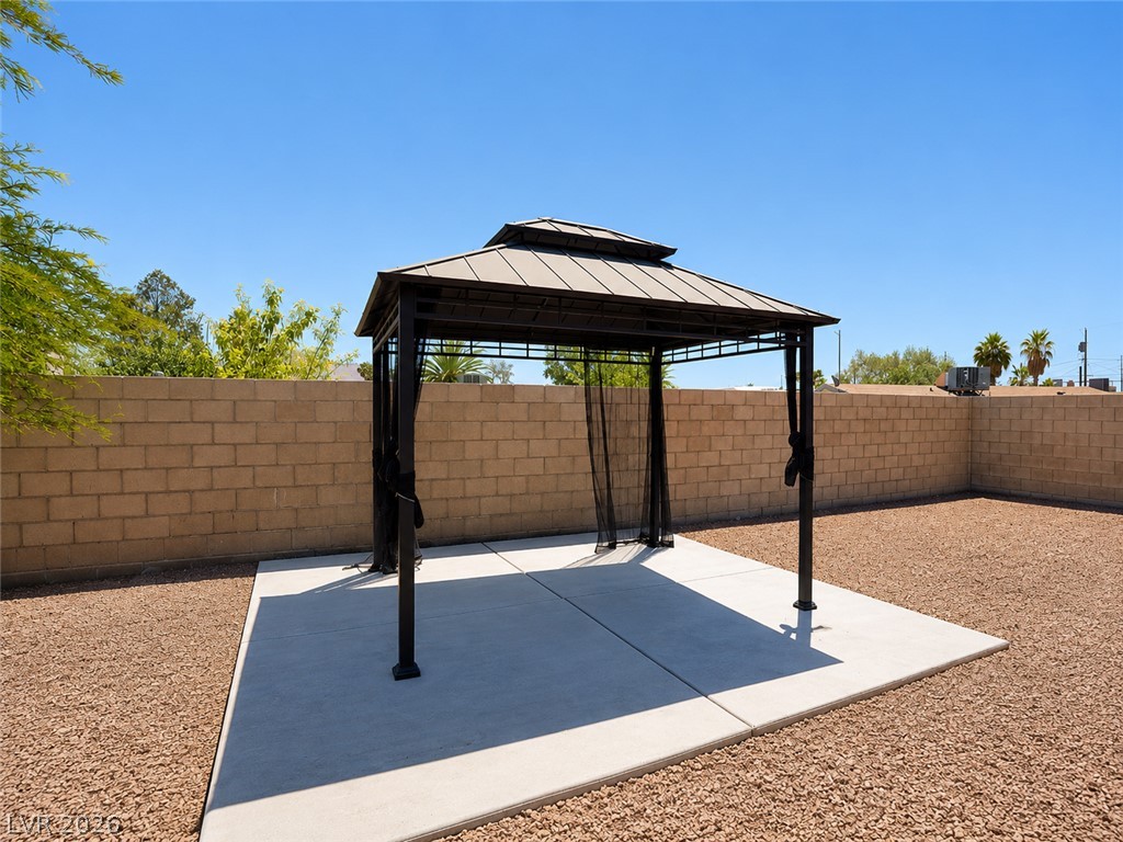 2870 South Sandhill Road Las Vegas, NV 89121 - Photo 22 of 64 A well-maintained concrete patio and gravel yard create an inviting outdoor space.