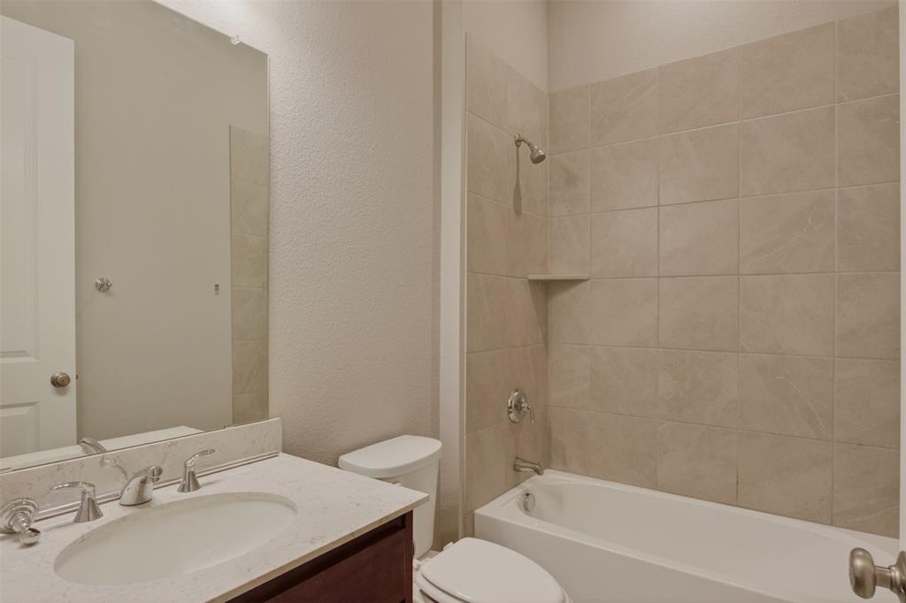 16812 Bitterroot Road Justin, TX 76247 - Photo 13 of 27 a bathroom with a sink toilet and shower