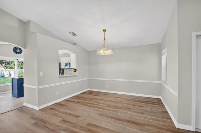 a view of room with window ceiling fan and wooden floor