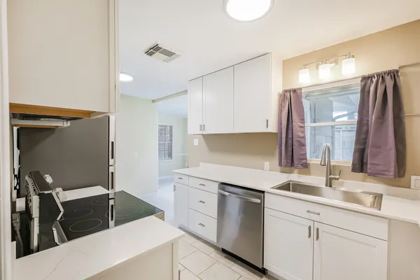 a kitchen with a sink and a refrigerator
