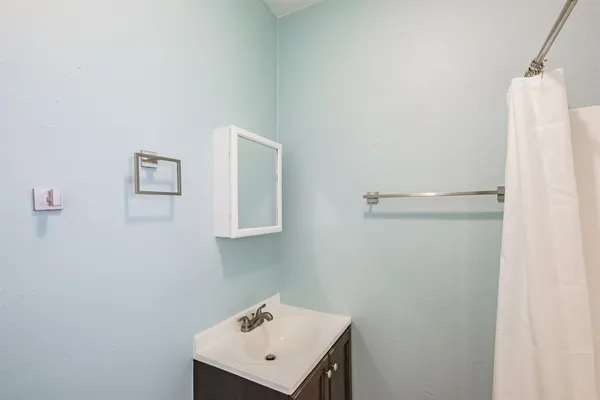 a bathroom with a shower and a mirror