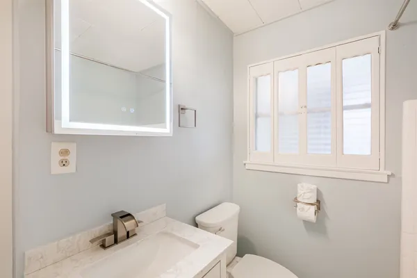 a bathroom with a sink a mirror and a shower