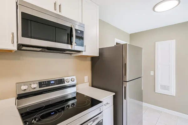 a kitchen with appliances and refrigerator