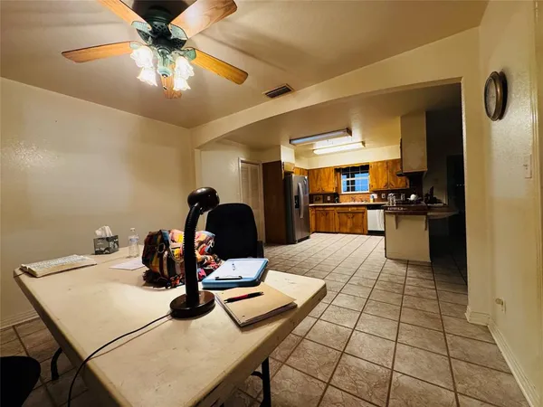 a kitchen with granite countertop a refrigerator stove and sink