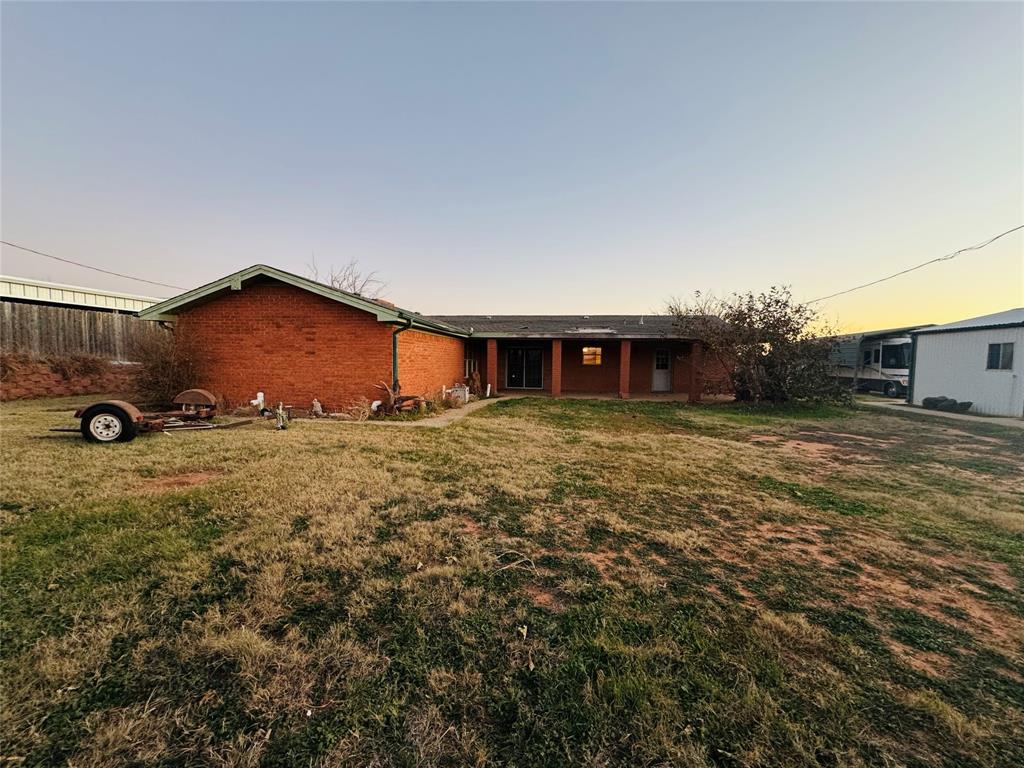 1111 East Sammy Baugh Avenue Rotan, TX 79546 - Photo 5 of 23 a view of a house with a yard