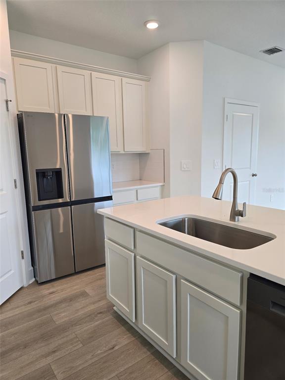 2445 Magnolia Reserve Road Ocoee, FL 34761 - Photo 11 of 19 a kitchen with wooden cabinets sink and refrigerator