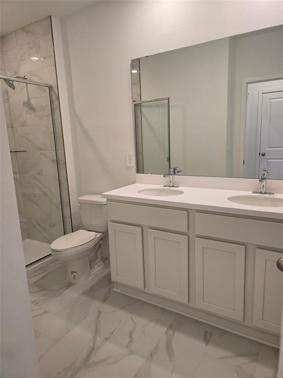 2445 Magnolia Reserve Road Ocoee, FL 34761 - Photo 15 of 19 a bathroom with a sink toilet vanity and shower