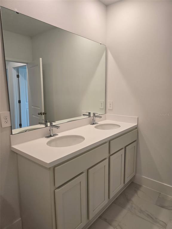2445 Magnolia Reserve Road Ocoee, FL 34761 - Photo 16 of 19 a bathroom with a sink and a mirror