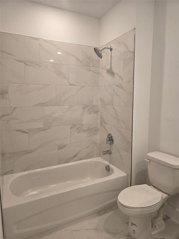 2445 Magnolia Reserve Road Ocoee, FL 34761 - Photo 17 of 19 a bathroom with a toilet and a bathtub