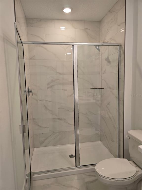 2445 Magnolia Reserve Road Ocoee, FL 34761 - Photo 18 of 19 a bathroom with a shower and a toilet