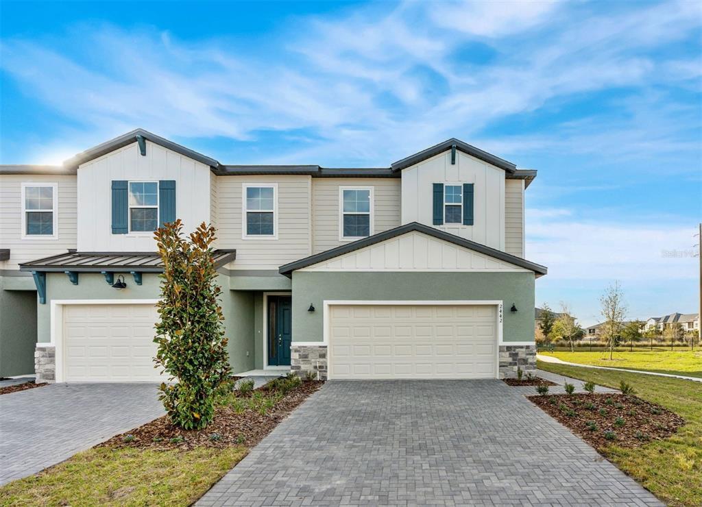 2445 Magnolia Reserve Road Ocoee, FL 34761 - Photo 2 of 19 a front view of a house with a yard