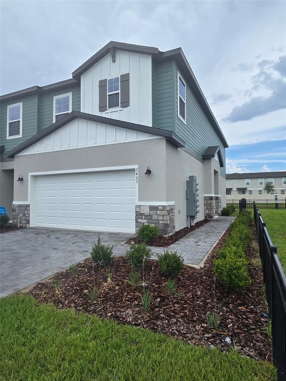 2445 Magnolia Reserve Road Ocoee, FL 34761 - Photo 4 of 19 a front view of a house with a yard and garage