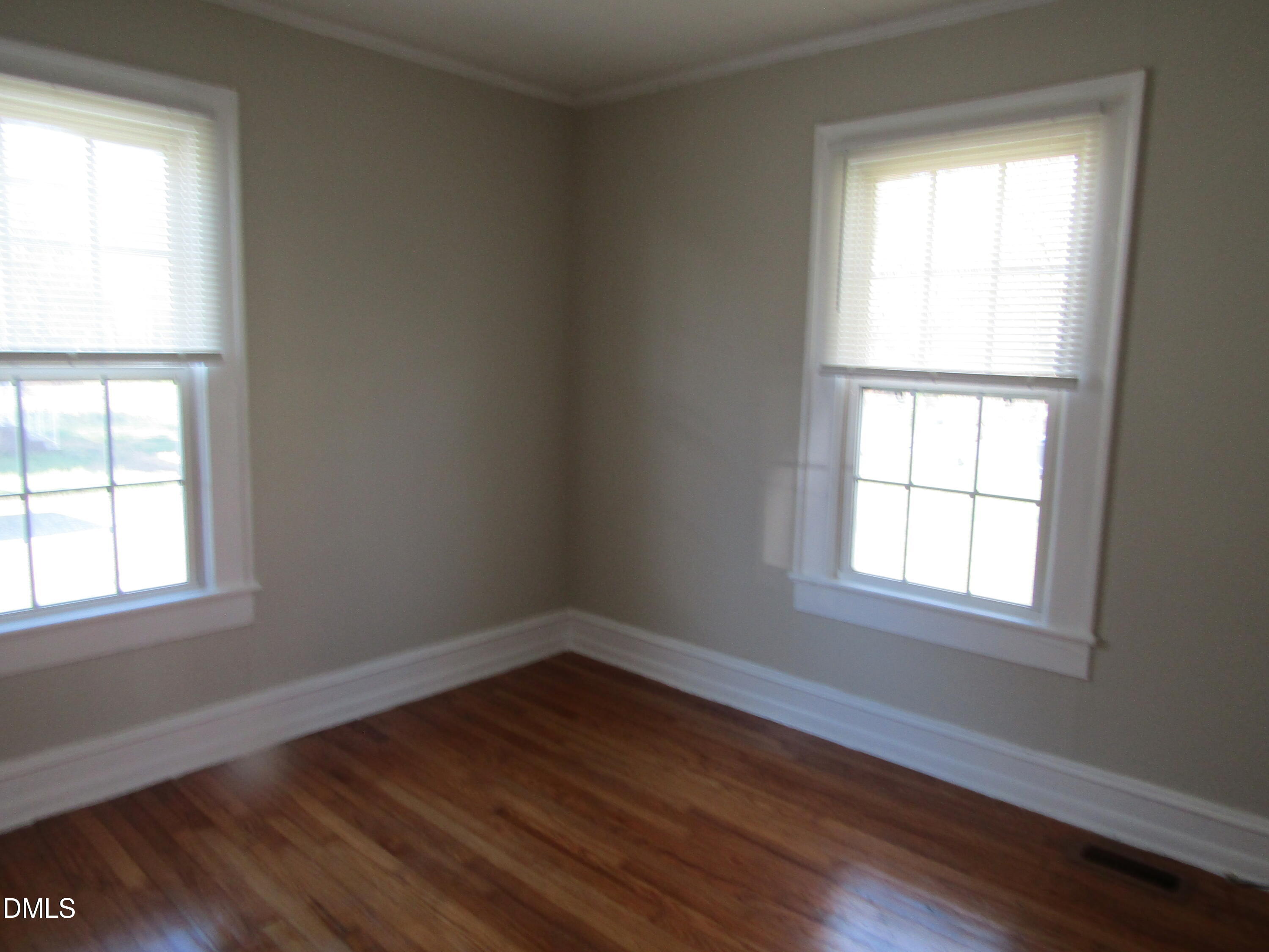 1719 Lower Hopedale Road Burlington, NC 27217 - Photo 6 of 12 an empty room with wooden floor and windows