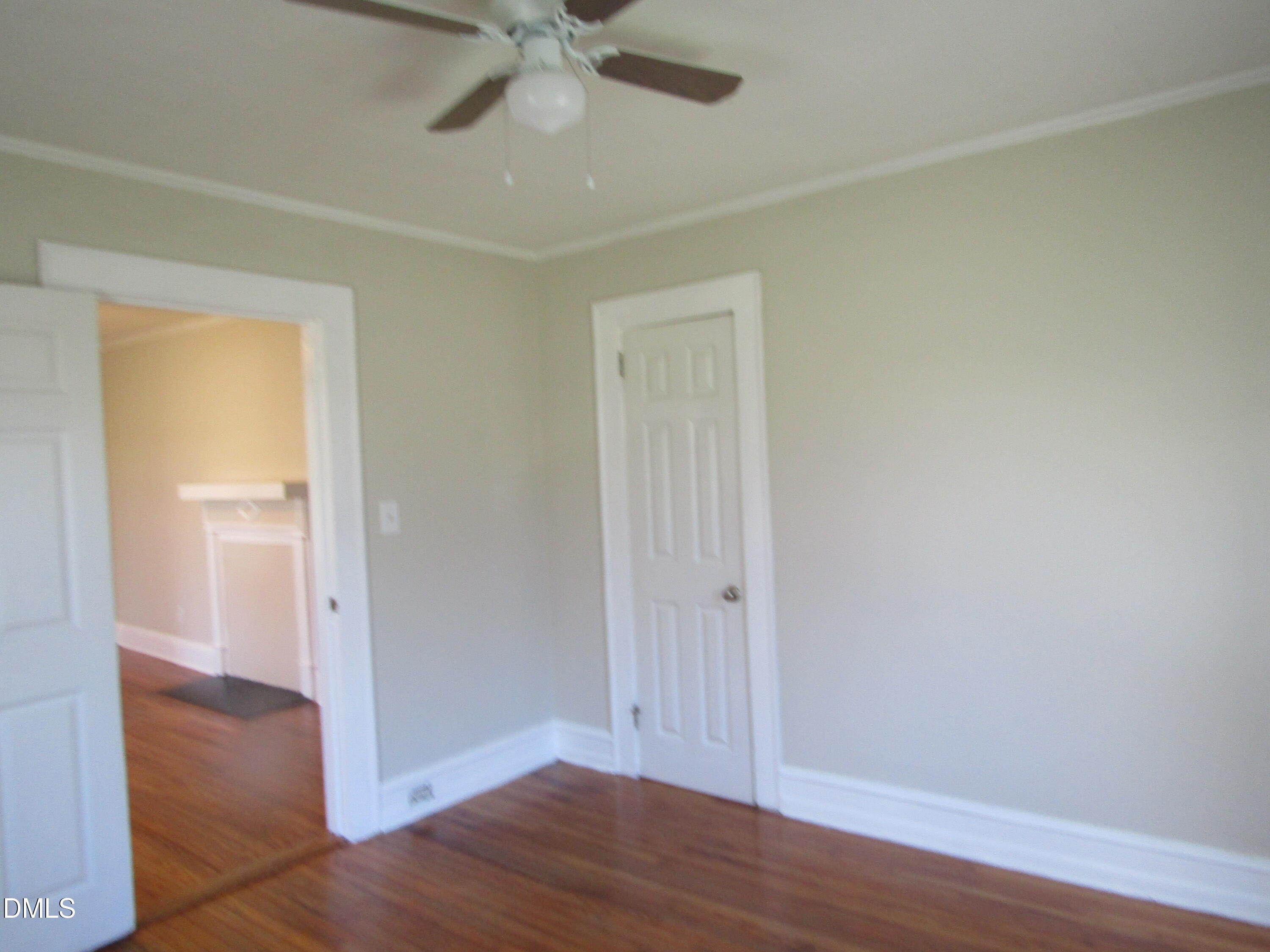1719 Lower Hopedale Road Burlington, NC 27217 - Photo 7 of 12 an empty room with wooden floor and closet