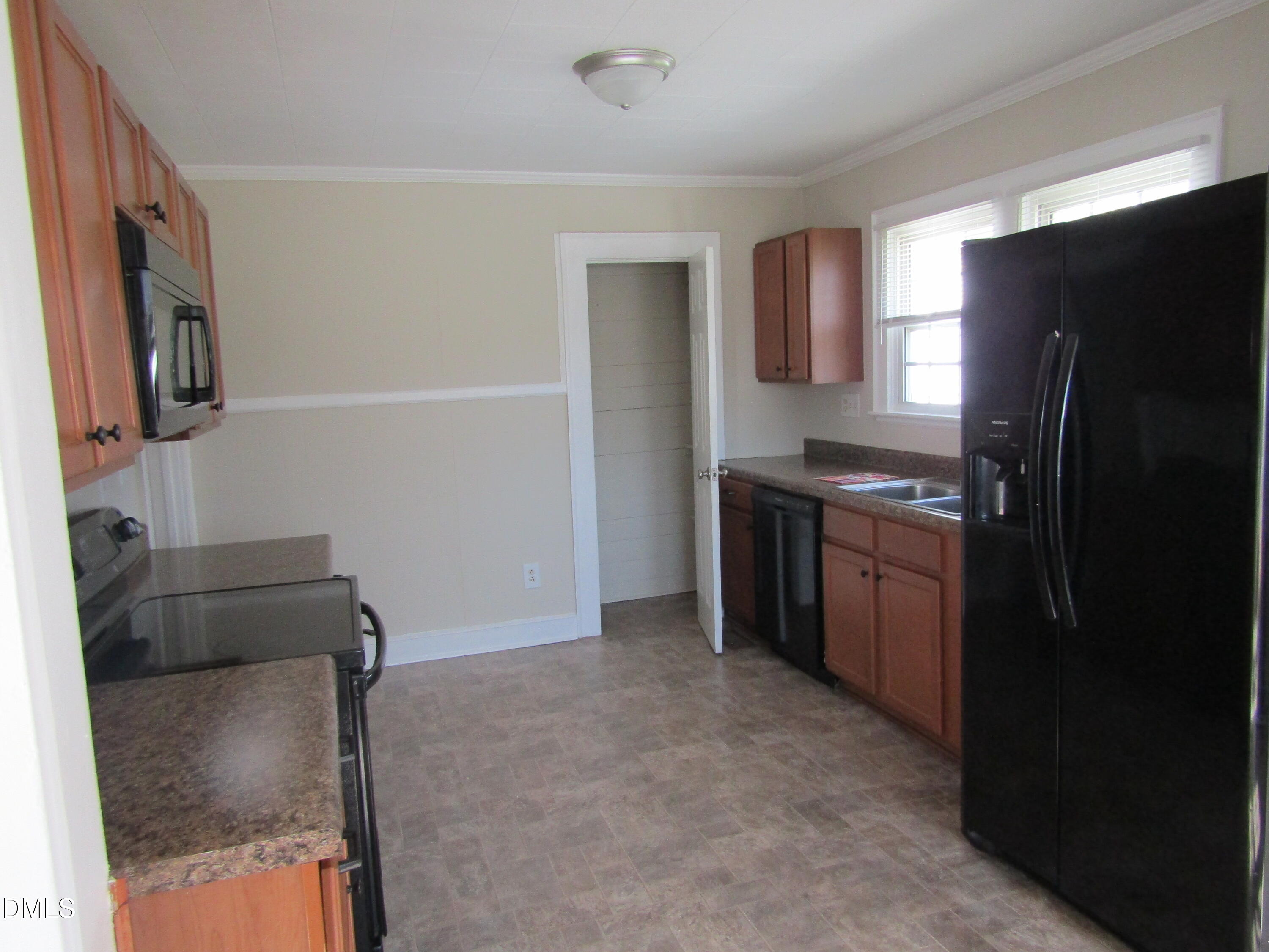 1719 Lower Hopedale Road Burlington, NC 27217 - Photo 9 of 12 a kitchen with stainless steel appliances a refrigerator and a stove
