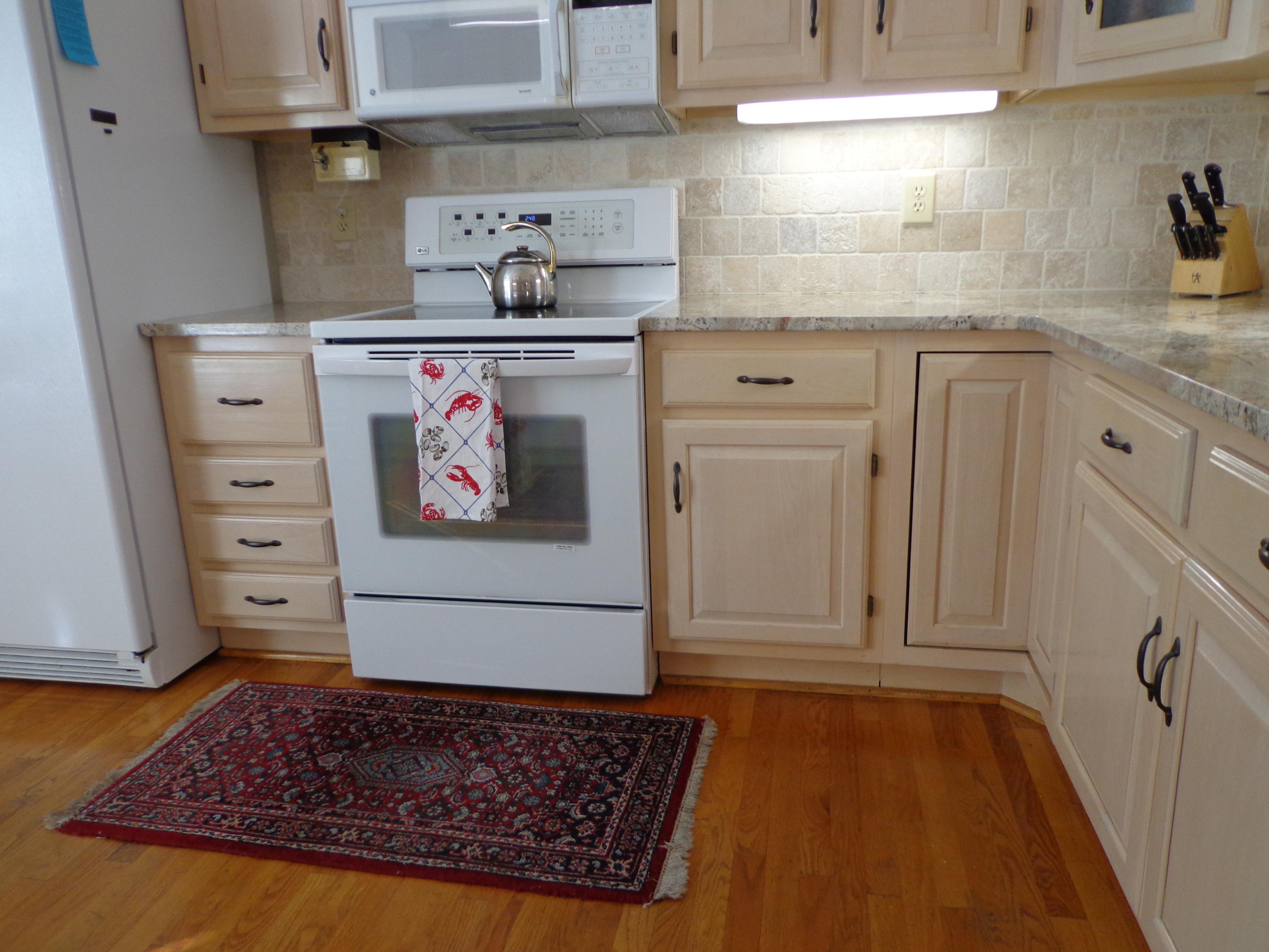 1908 McVitty Road Salem, VA 24153 - Photo 14 of 44 a kitchen with cabinets and wooden floor