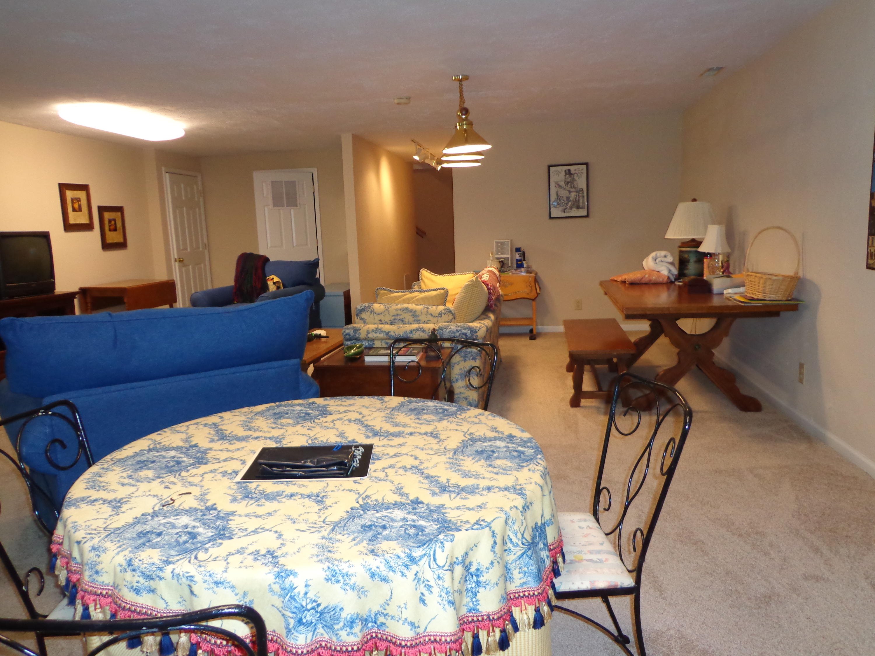 1908 McVitty Road Salem, VA 24153 - Photo 40 of 44 a living room with furniture a dining table and a chandelier