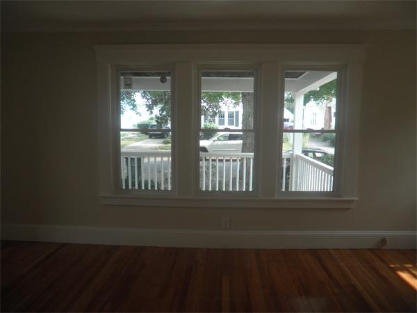 44 Thorndyke Street Springfield, MA 01118 - Photo 3 of 17 a view of an empty room with wooden floor and a window