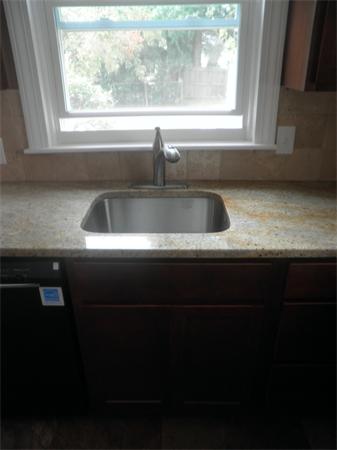 44 Thorndyke Street Springfield, MA 01118 - Photo 6 of 17 a kitchen with a sink a window and a stove