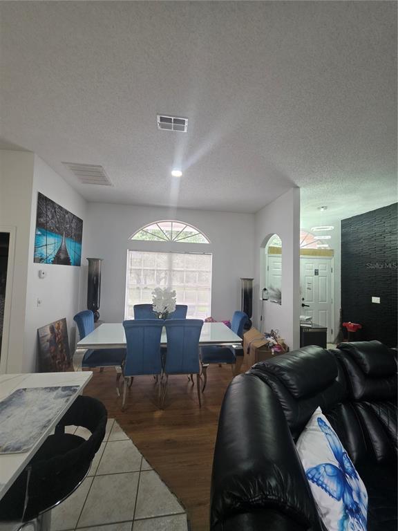 17820 Monteverde Drive Spring Hill, FL 34610 - Photo 17 of 42 a living room with furniture and a large window