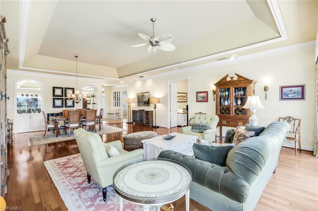 15588 Whitney Lane Naples, FL 34110 - Photo 11 of 47 a living room with furniture a rug and a chandelier