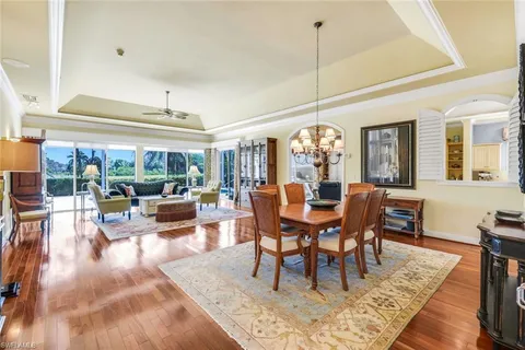 a living room with furniture a fireplace and a large window