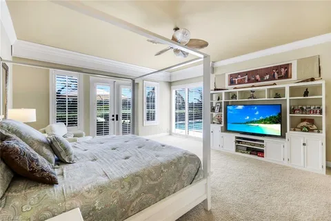a spacious bedroom with a bed and large windows