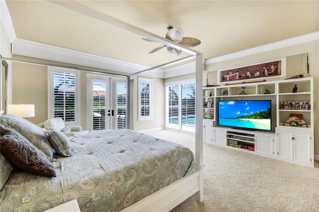 15588 Whitney Lane Naples, FL 34110 - Photo 15 of 47 a bedroom with a bed and a flat screen tv