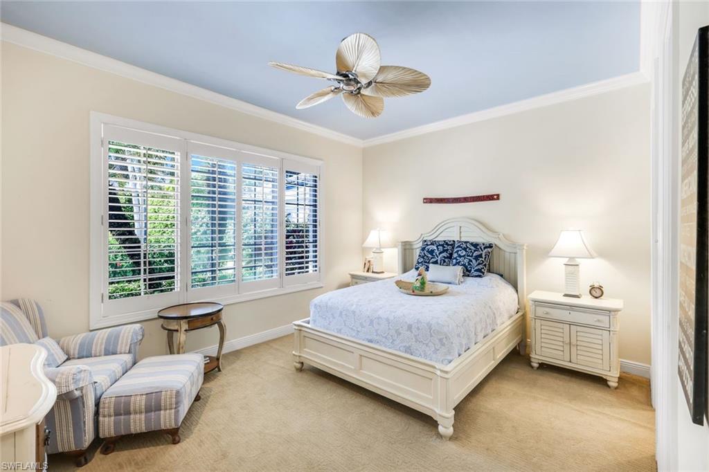 15588 Whitney Lane Naples, FL 34110 - Photo 19 of 47 a spacious bedroom with a bed and a couch