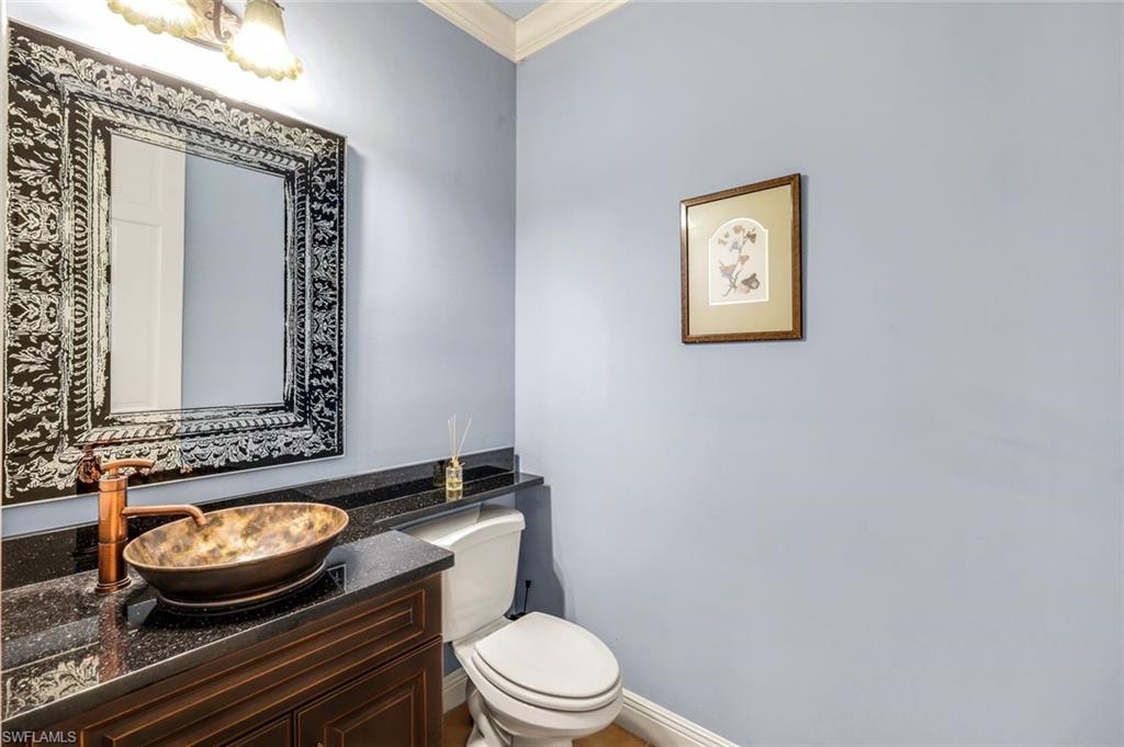 15588 Whitney Lane Naples, FL 34110 - Photo 22 of 47 a bathroom with a toilet and a mirror