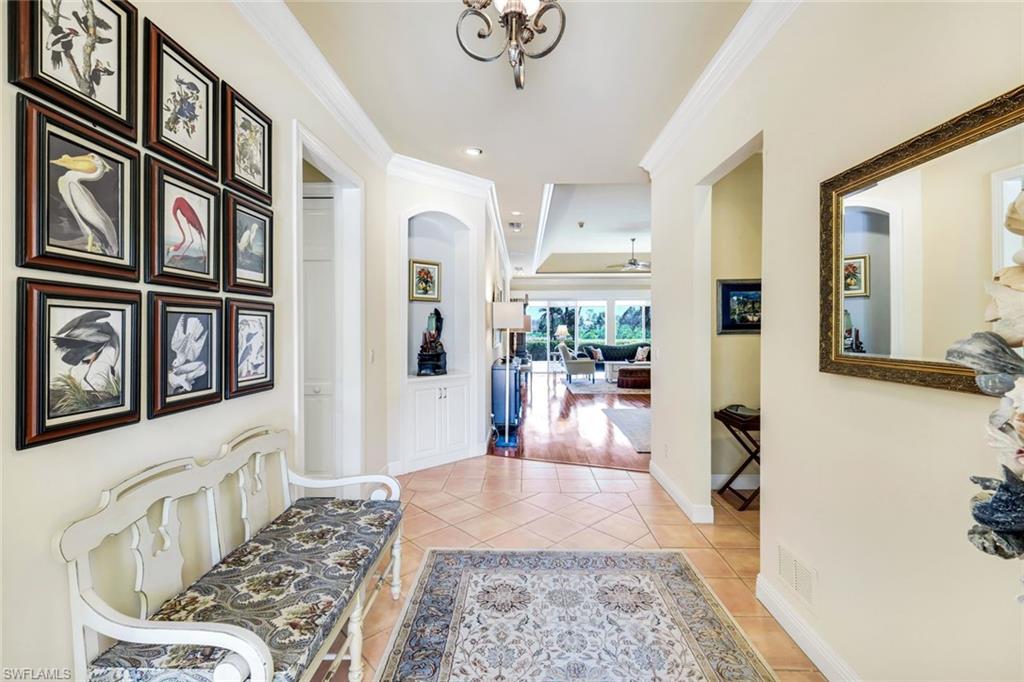 15588 Whitney Lane Naples, FL 34110 - Photo 23 of 47 a living room with stainless steel appliances furniture a rug and a view of kitchen