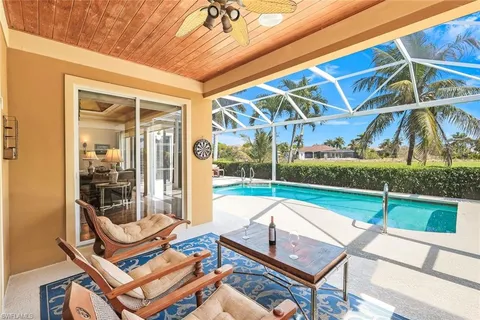 a view of a house with swimming pool and sitting area