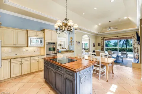a kitchen with stainless steel appliances granite countertop a sink and a refrigerator