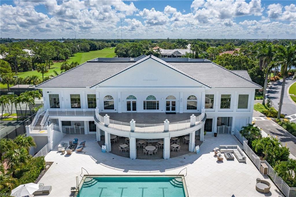 15588 Whitney Lane Naples, FL 34110 - Photo 42 of 47 a aerial view of a house with a yard table and chairs